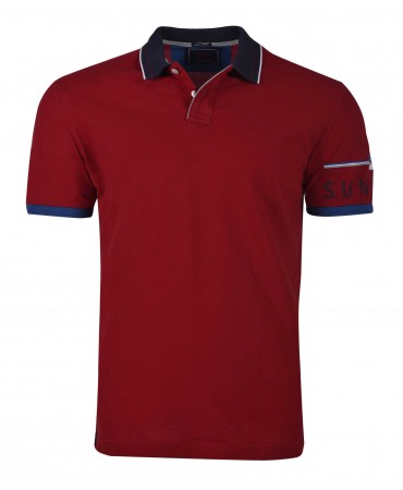 Red polo shirt with blue finish and logo on the Makis Tselios sleeve