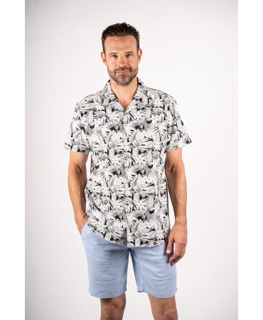 Printed shirt on a white base with black leaves and flowers